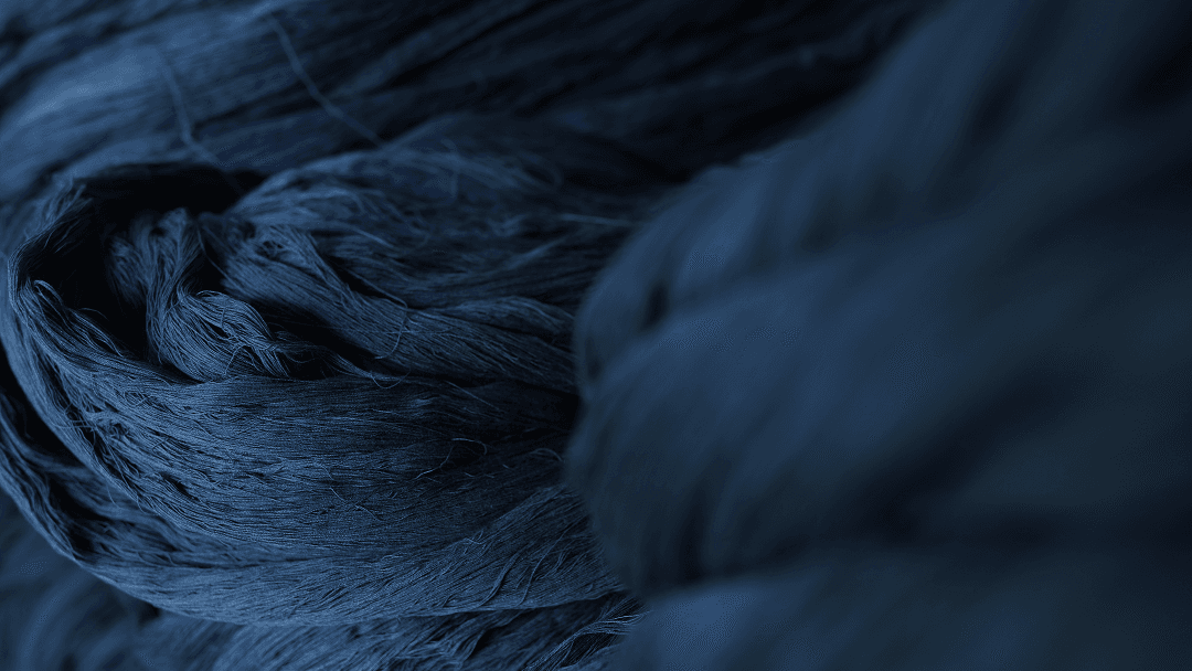 Deep indigo-dyed yarn showcases the rich tones and texture achieved through traditional natural dyeing techniques.